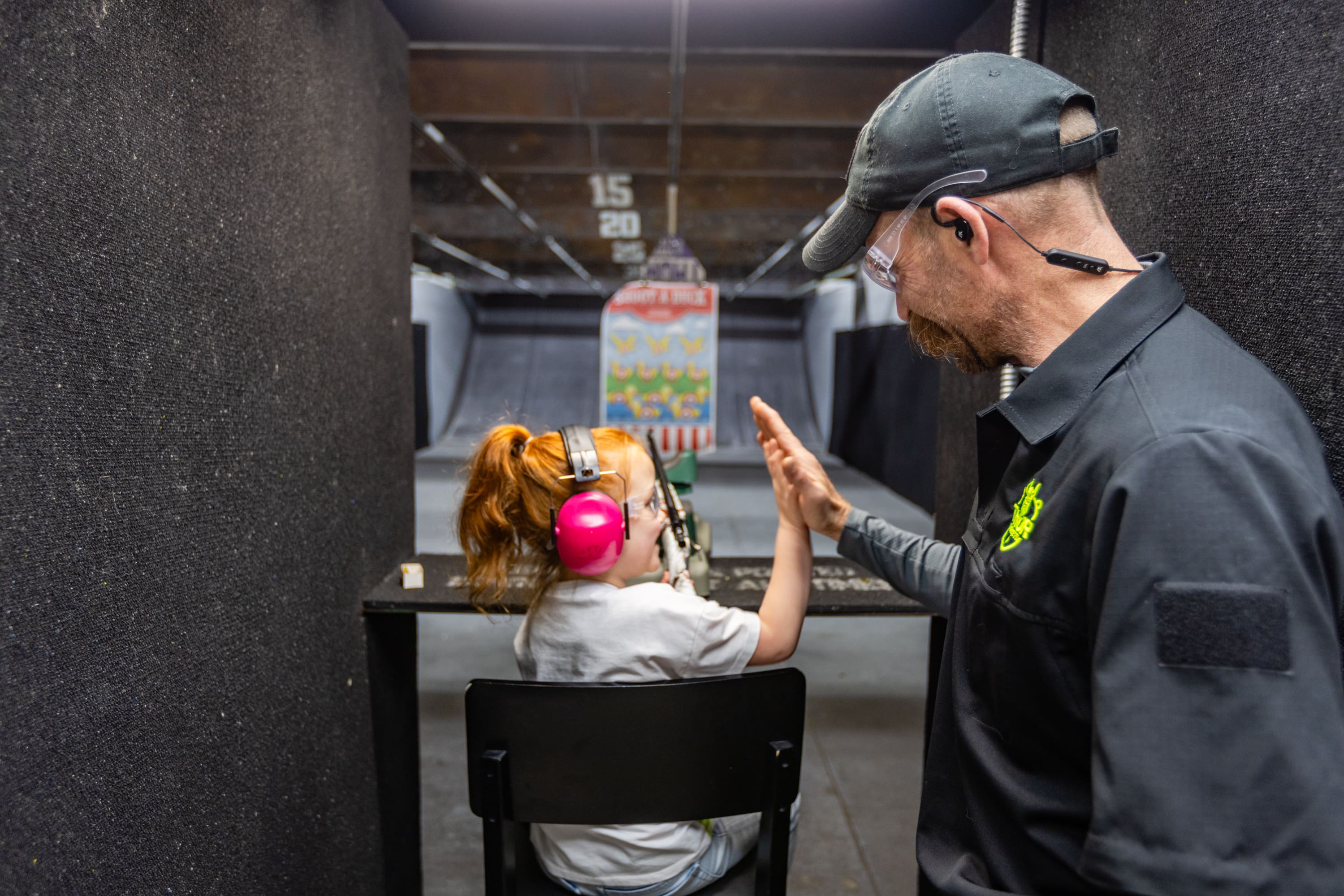 A man and woman are in the shooting range.